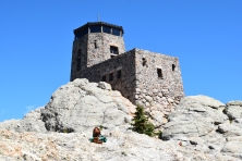 Lamar sitting in front of the lookout tower, Black Elk Peak